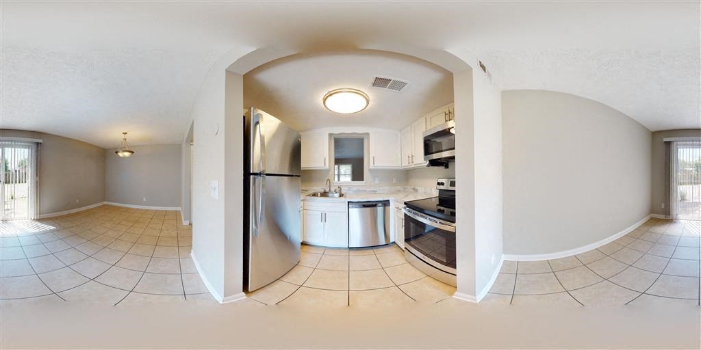 a view of a kitchen and a living room