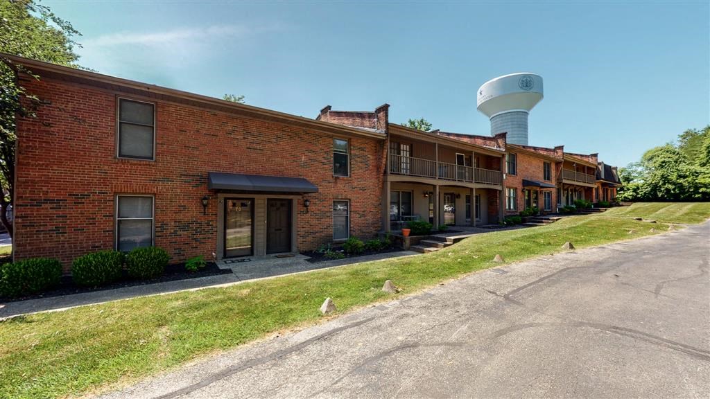 a row of brick buildings with a water tower in the background