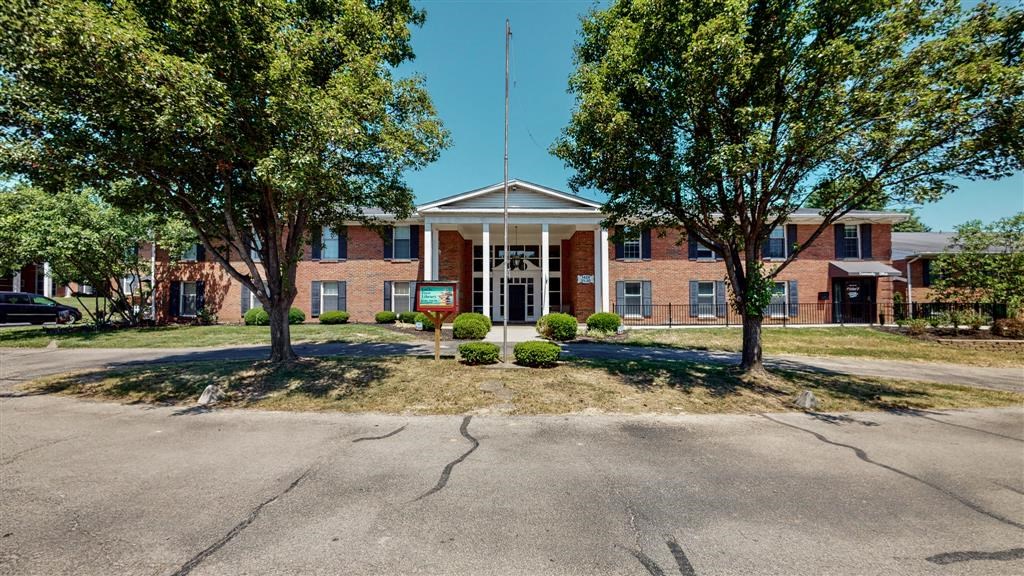 a large brick building with trees in front of it