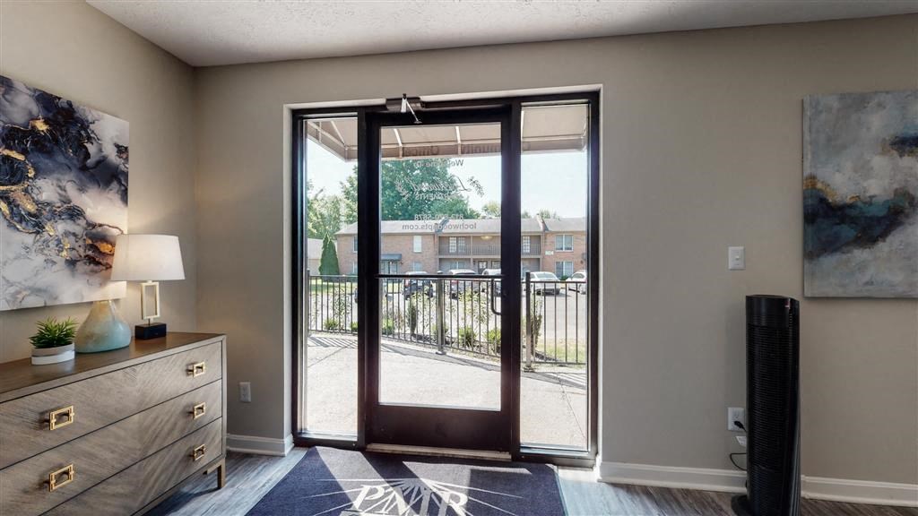 a living room with a sliding glass door to a balcony