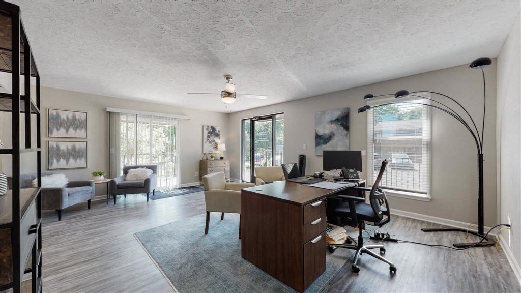 a living room with a desk and a computer