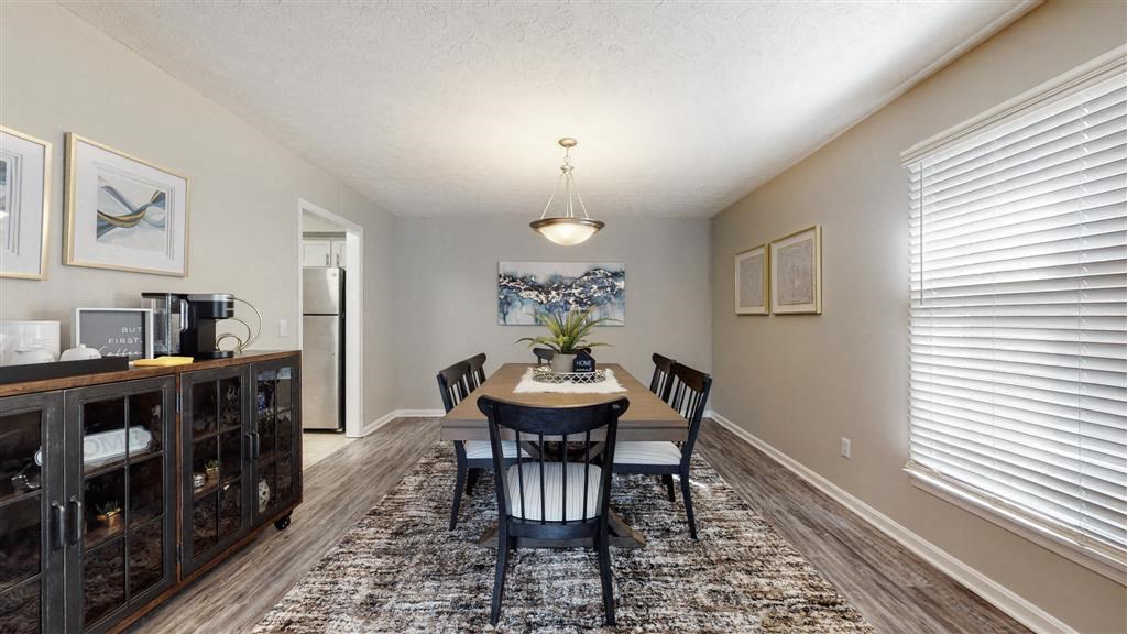 a dining room with a table and chairs