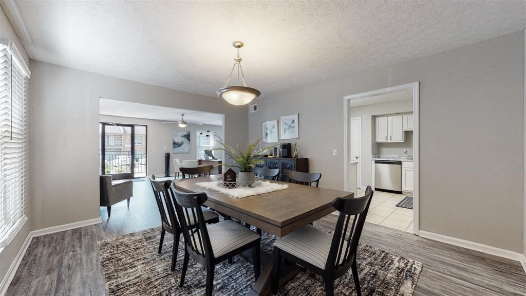 a dining room and living room with a table and chairs