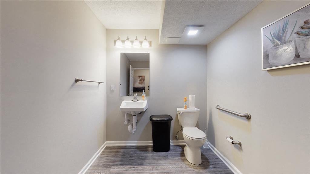 a bathroom with a toilet and a sink and a mirror