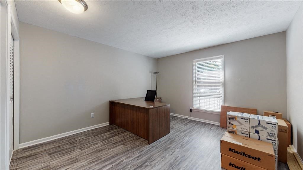 an empty room with boxes and a desk and a window