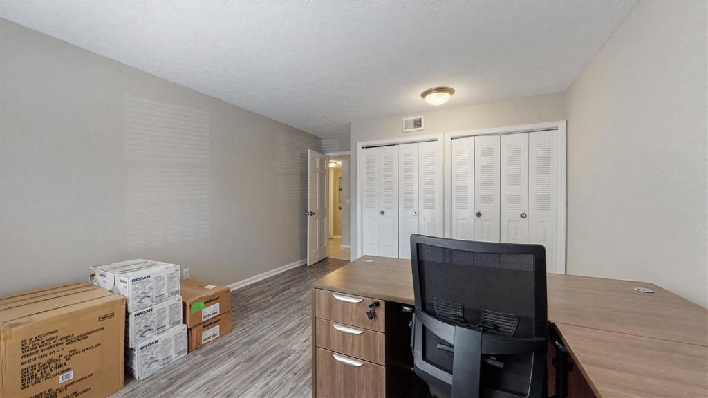 a room with a desk and a chair and boxes