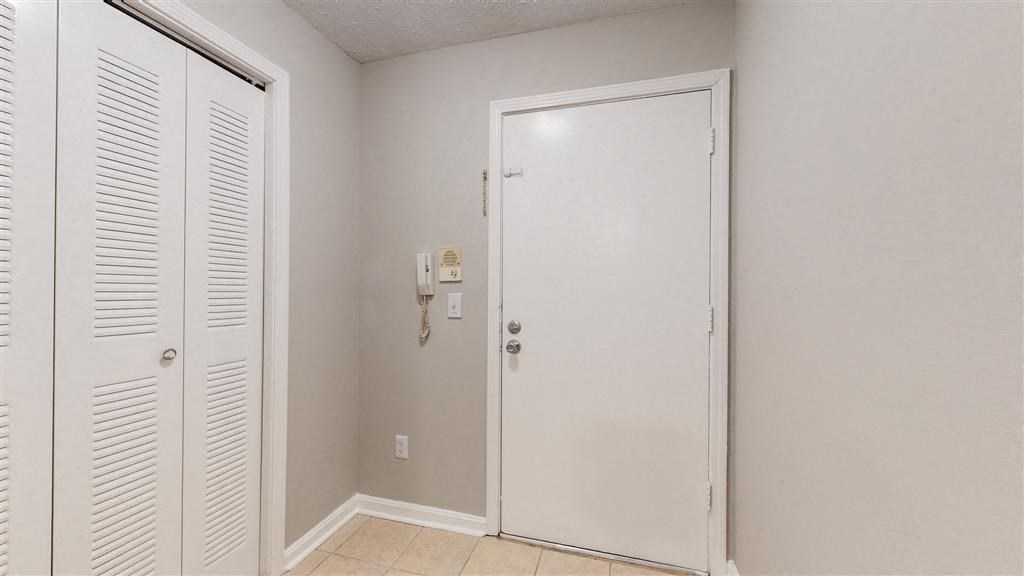 a bathroom with a white door and a closet