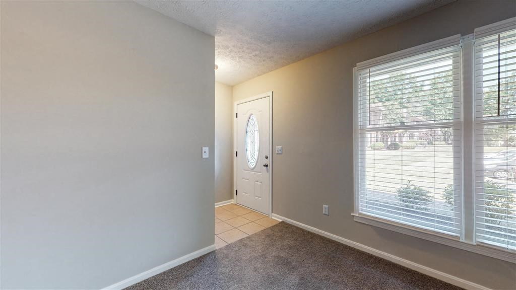 a living room with a large window and a white door