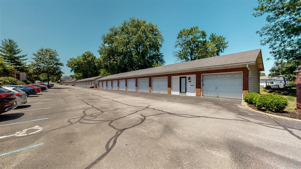a parking lot in front of a building with cars parked