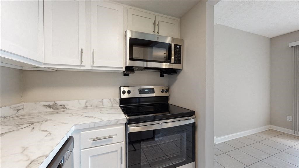 a kitchen with a stove and a microwave