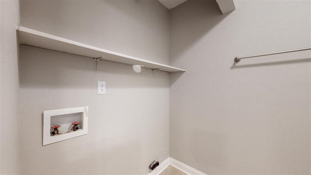 a white room with a picture on the wall