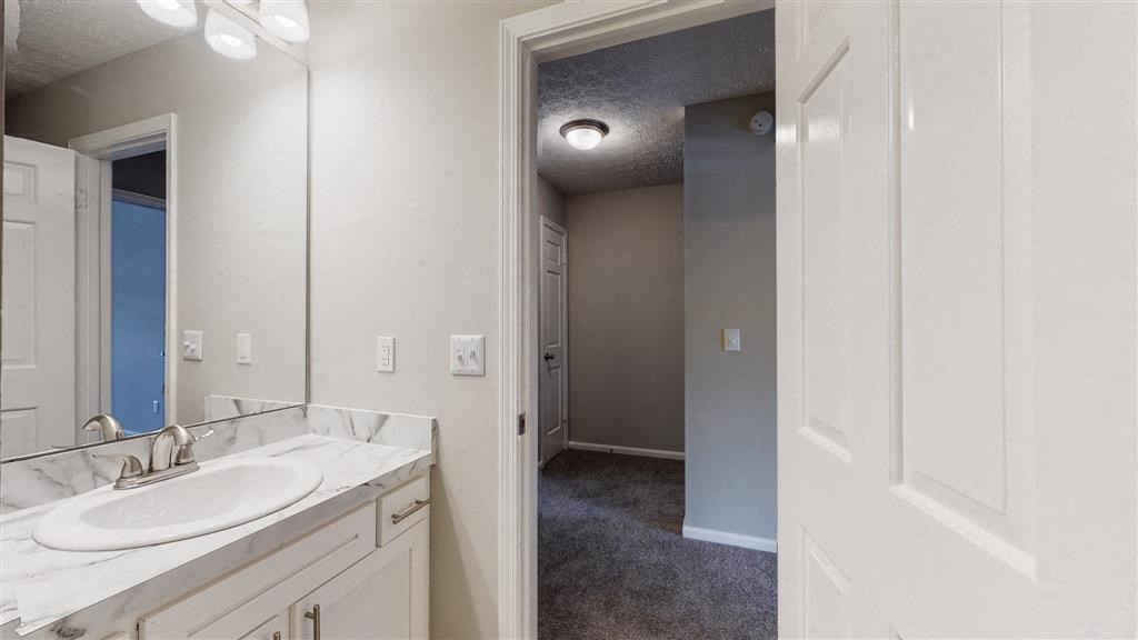 an empty bathroom with a sink and a mirror