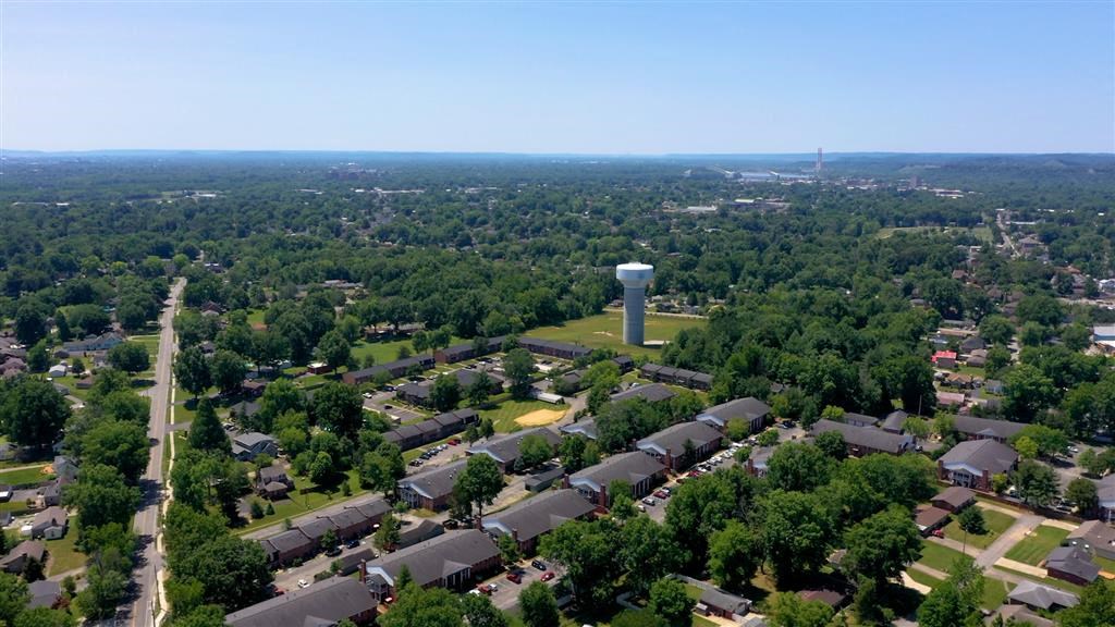an aerial view of a neighborhood with houses and a water tower