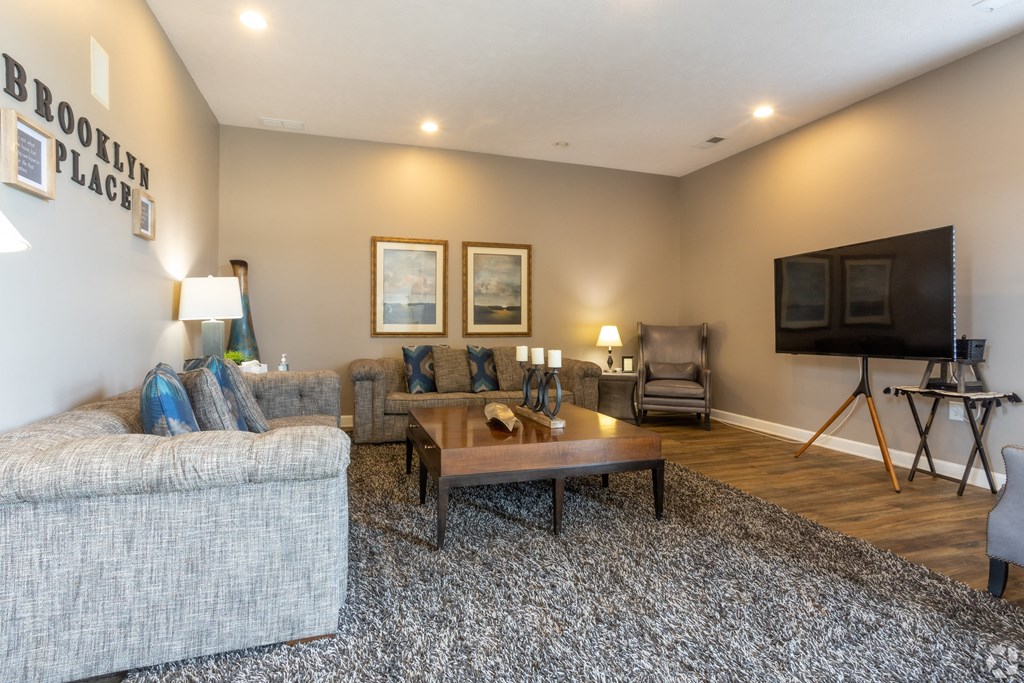 a living room with couches a coffee table and a television