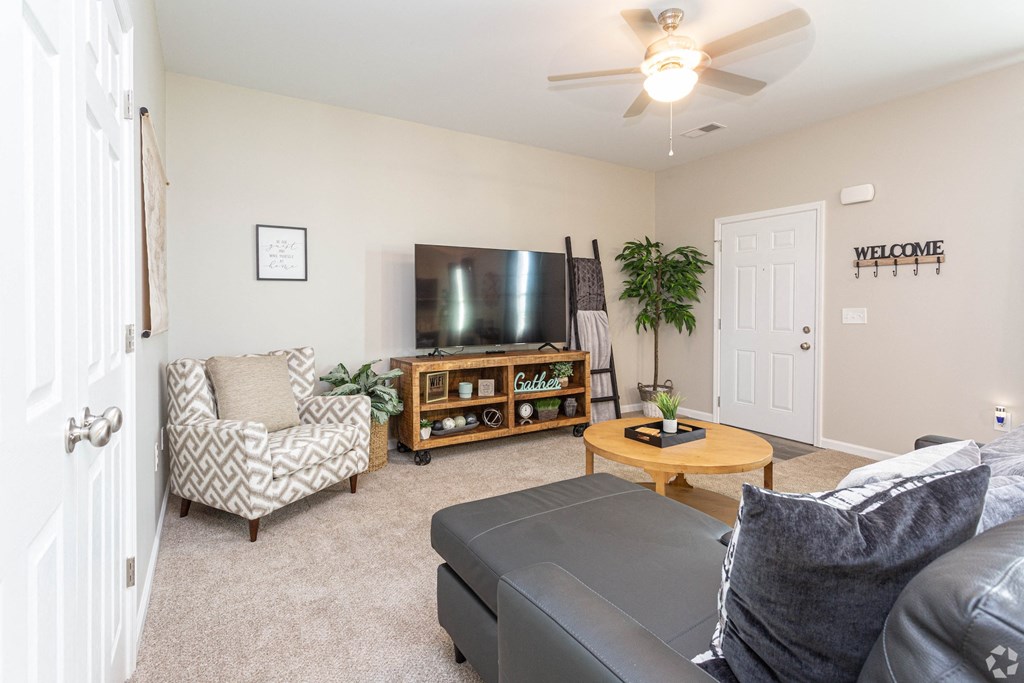 the living room of a home with a couch and a tv