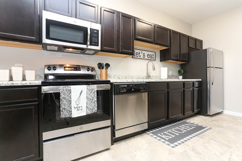 a kitchen with stainless steel appliances and black and white cabinets