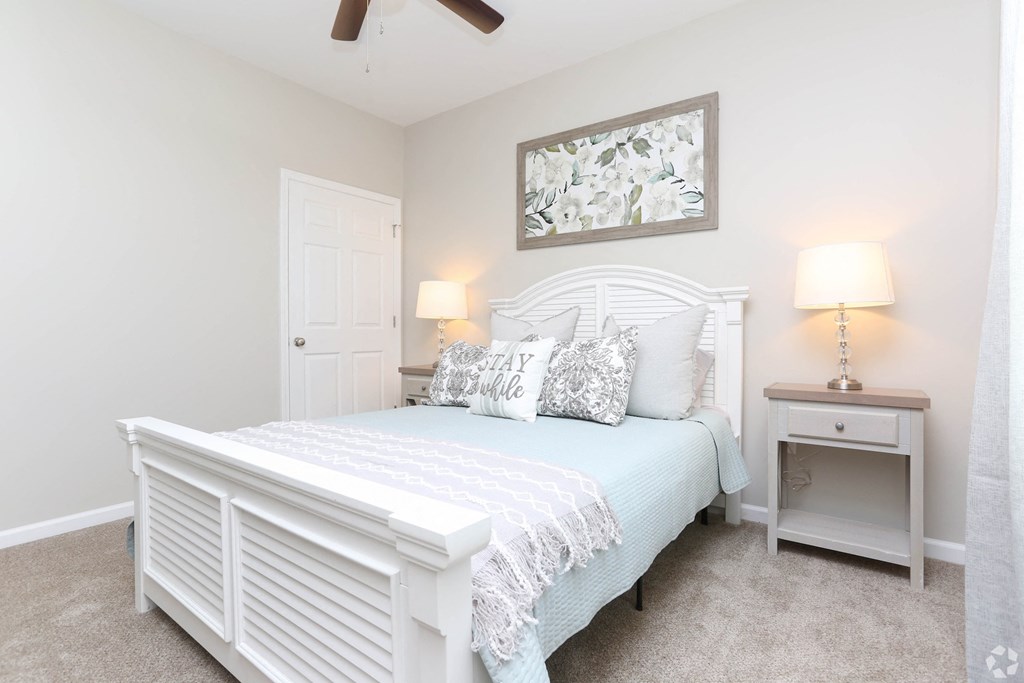 a bedroom with a white bed and a white closet
