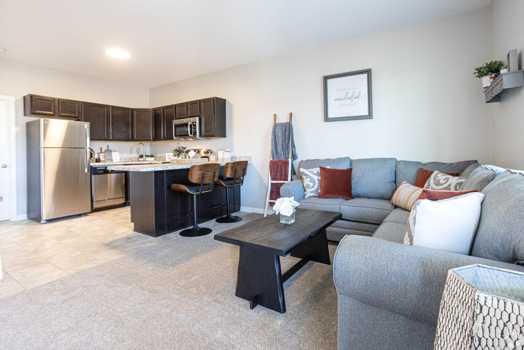 a living room with a couch and a kitchen