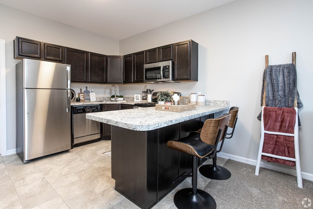 a kitchen with stainless steel appliances and a granite counter top