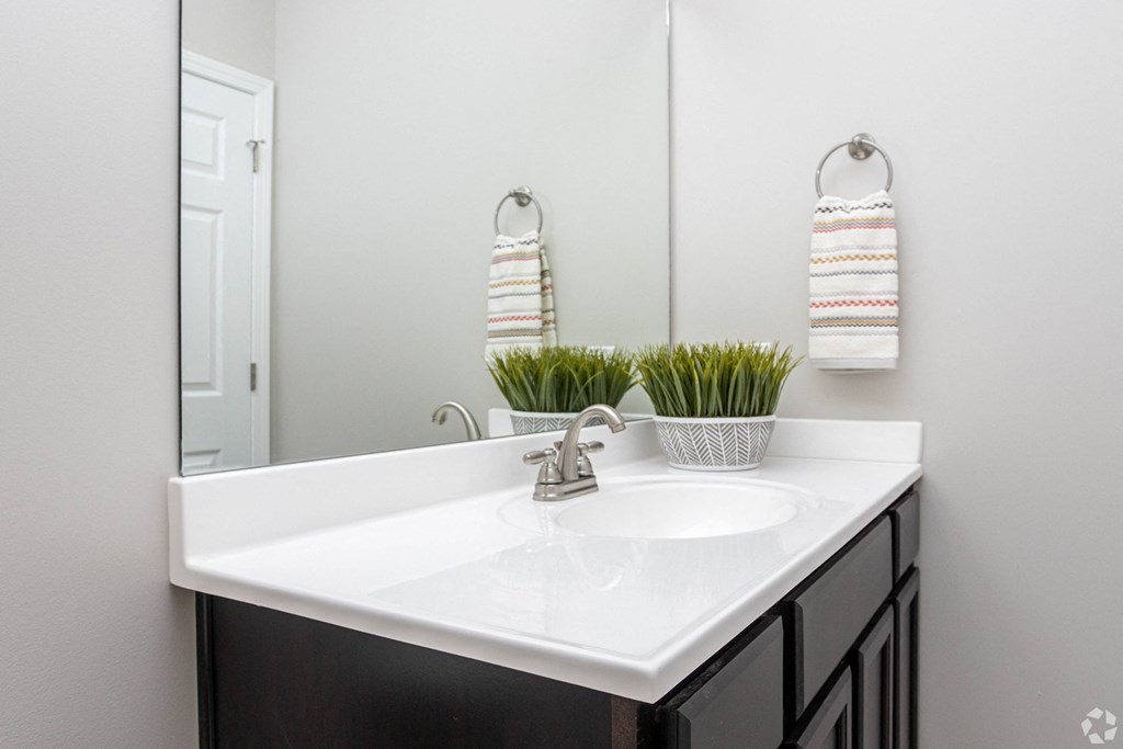 an empty bathroom with a sink and a mirror