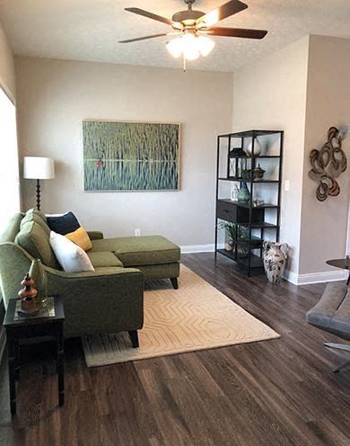 a living room with a couch and a ceiling fan