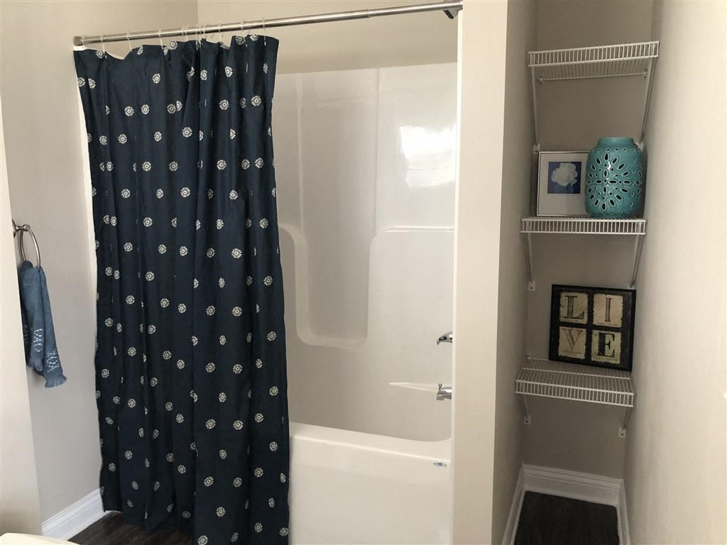 a bathroom with a shower and a shower curtain