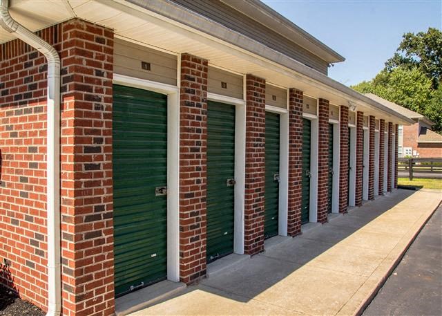a row of garage doors on a brick building