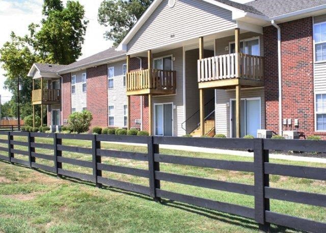 a house with a wooden fence in front of it