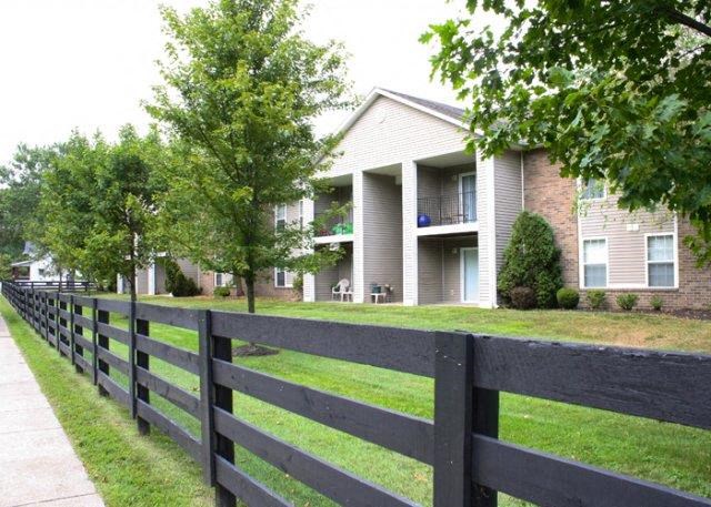 a house with a black fence in front of it