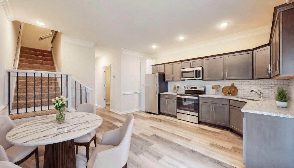 A modern kitchen with a dining table and chairs.