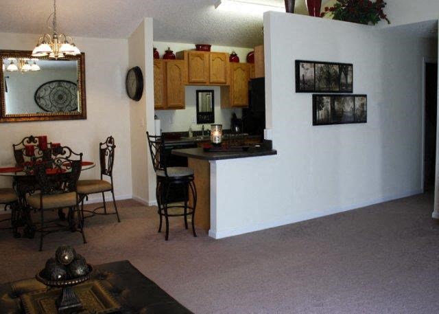 a living room with a kitchen and a dining room