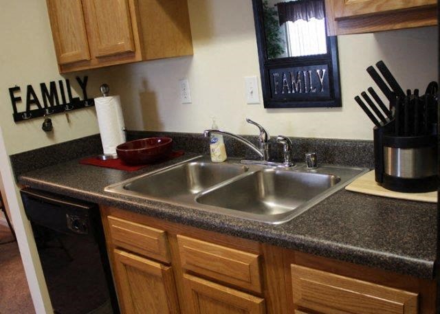 a kitchen with a sink and wooden cabinets