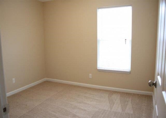 an empty room with a window and a door