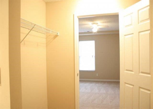 an empty bathroom with a closet and a window