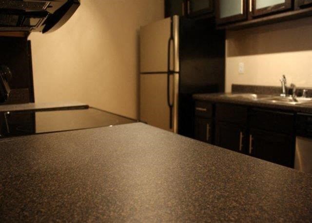a kitchen with a counter top and a refrigerator