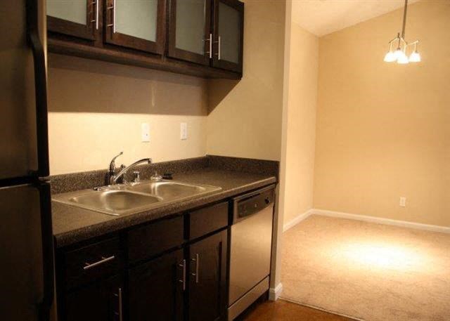 a kitchen with a sink and a refrigerator