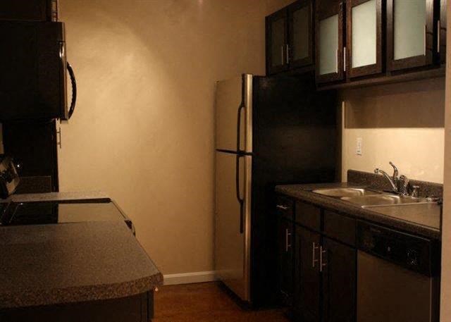 a kitchen with a sink and a refrigerator
