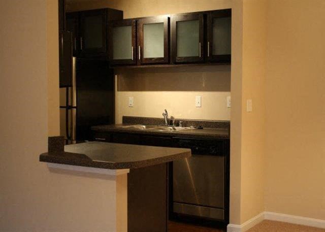 a kitchen with a sink and a refrigerator