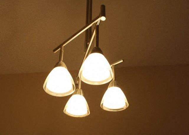 three white lights hanging from a ceiling