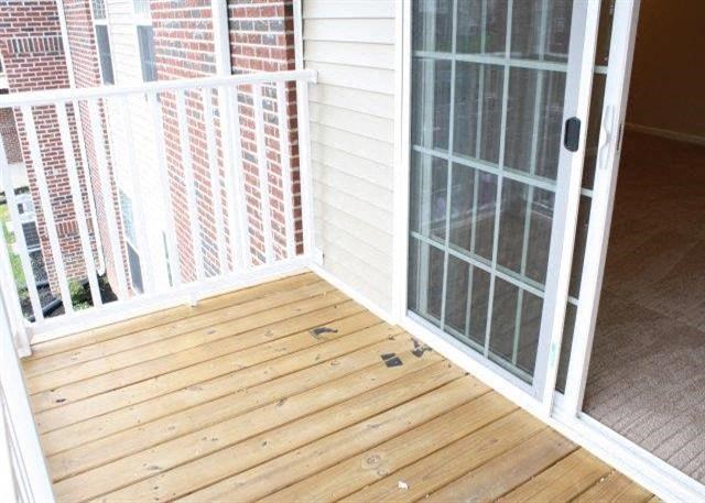 a wooden porch with a glass door