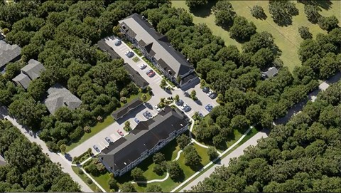 An aerial view of a building surrounded by trees.