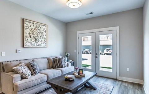 A living room with a grey couch and a coffee table.
