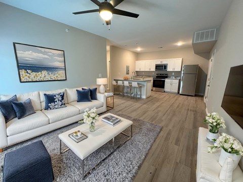 A living room with a white couch and a coffee table.