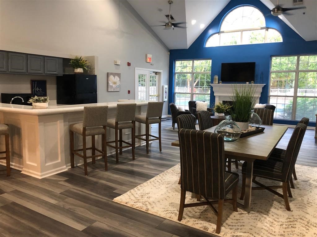 a dining room and kitchen with a table and chairs