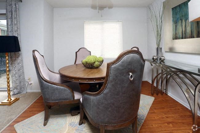 a dining room with a table and two chairs