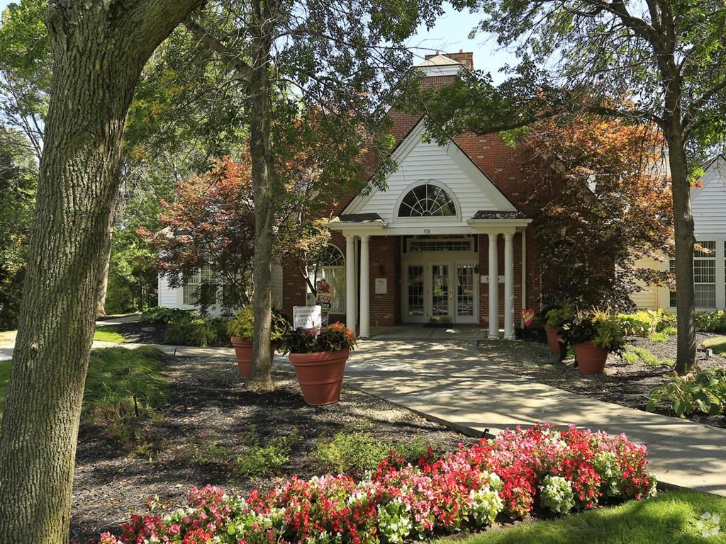 a white house with potted flowers in front of it