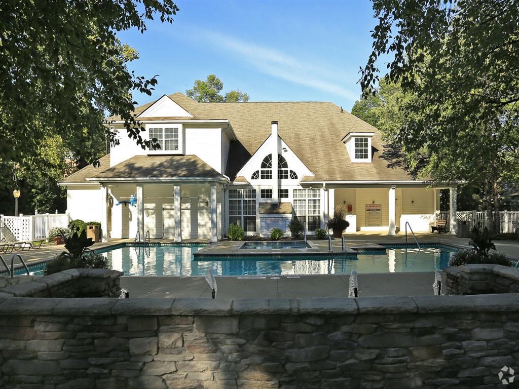 a house with a swimming pool in front of it