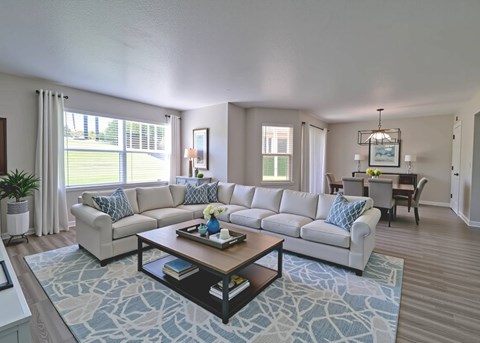 A living room with a large sectional sofa and a coffee table.