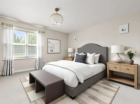 A bedroom with a large bed, a nightstand, and a window with curtains.