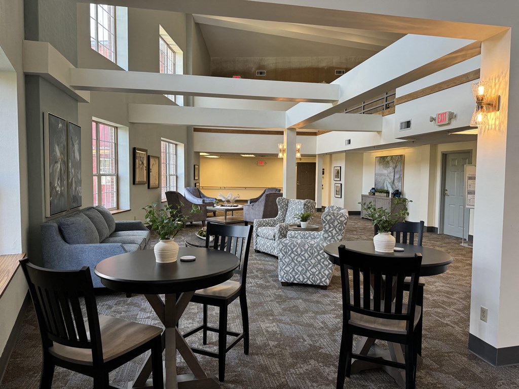 a large living room with tables and chairs